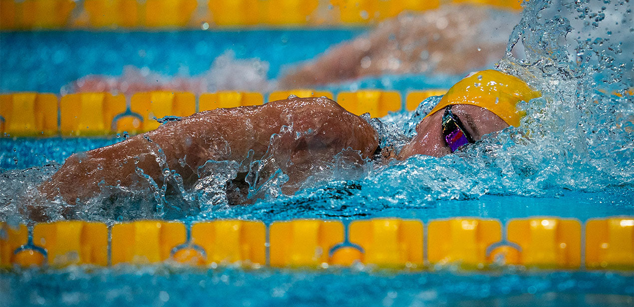 Madi Wilson swimming freestyle in yellow cap